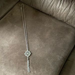 Long necklace. Silver. Pendant has rhinestones.